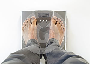 Feet on a bathroom scale slim photo