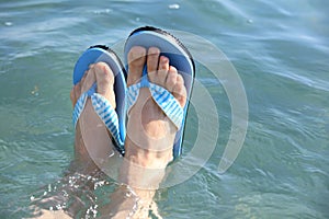 Feet in beach slippers