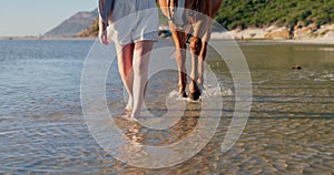 Feet, beach and woman with a horse walking to water in nature for travel, adventure and trip. Island, resort and legs of