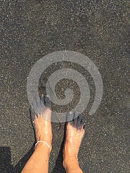 Feet on a black beach