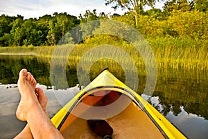 Feet in boat on lake