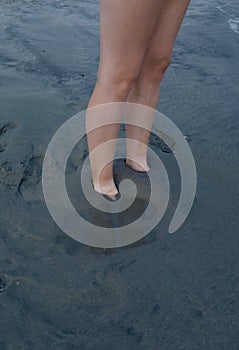 Feet Buried in Sand at Beach