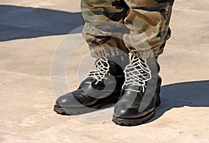 Feet of camouflaged soldier