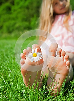 Feet of a child with flower