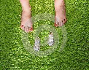 The feet of the child have grown large, and the shoes are very small. Concept of new shoes for children. Children`s feet grow ver