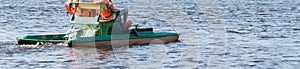 Feet of a child in rubber slippers pedaling a catamaran on the water, long photo