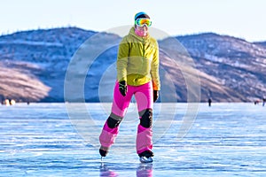 Feet close-ups of skates on legs A brightly colored dressed woman on the blue ice of Lake Baikal