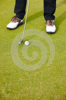 Feet, club and ball for sports on golf course, training and practice for competition or tournament. Closeup, shoes and
