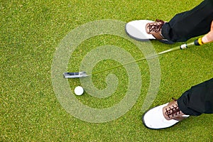 Feet, club and golf ball for practice on field, training and driver for competition or tournament. Closeup, top view and