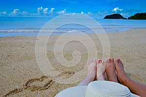 feet of couple on the beach