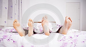 Feet of a couple sleeping side by side