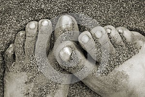 Feet covered with sand