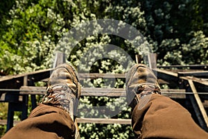Feet dangling from abandoned railroad trestle