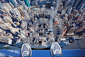 Feet on the edge of tall building