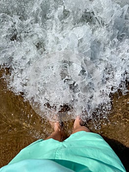 Feet in Foaming Sea Waves