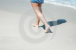 A Feet and footprints by the seashore in nature travel vacation background