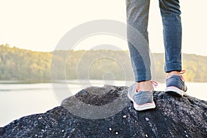 Feet girl standing on the rock in nature winter season