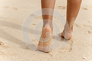 Feet girls running on the white sand beach
