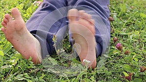 feet on the grass, small children's heels, dirty feet, foot play,soft green grass, sitting on the ground, get up and