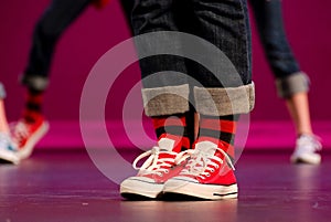 Feet of a hip-hop performer in red sneakers