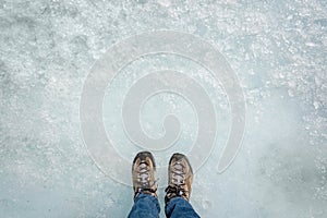 Feet on ice background, walking on Athabasca glacier in Columbia Icefield, Jasper National park, Rocky Mountains, Alberta Canada