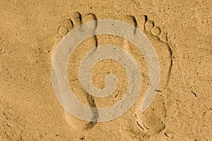 Feet imprint in sand photo