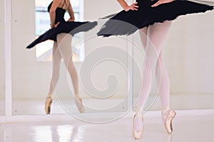 Feet and legs of ballet dancer dancing in a studio, practicing dance in class and student rehearsing before a