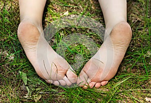 Feet of little girl outdoors