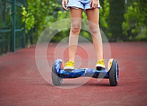 Feet of the little girl riding on a segway