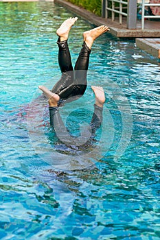 Feet looking out upside down from swimming pool. Summe fun vacation