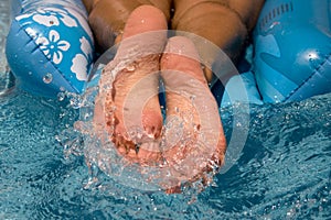 Feet of a man splashing in water