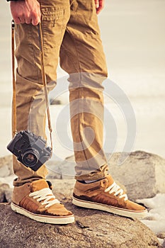 Feet man and vintage retro photo camera outdoor
