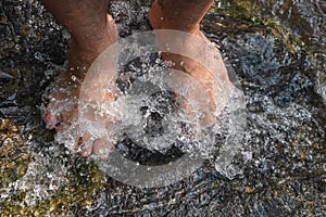 Feet Man in waterfall ,Lifestyle Travel concept waterfall in the forest