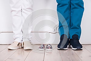 Feet of a married couple in anticipation of a baby