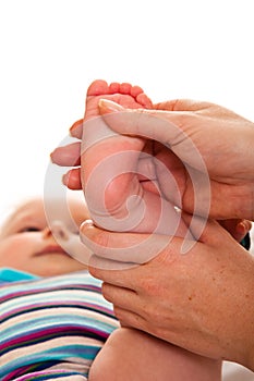 Feet massage of infant girl