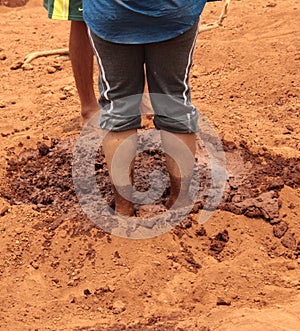 Feet in mud to prepare wet slurry