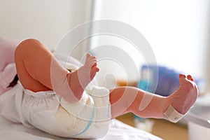 Feet of Newborn baby child seconds and minutes after birth lying on towel