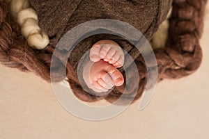 Feet of the newborn baby, fingers on the foot, maternal care, love and family hugs, tenderness.