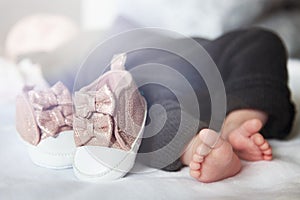 Feet of newborn baby. Footwear and baby shoe. Beautiful conceptual image of motherhood.