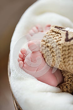 Feet of a newborn baby sleeping on white blanket