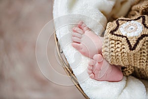 Feet of a newborn baby sleeping on white blanket