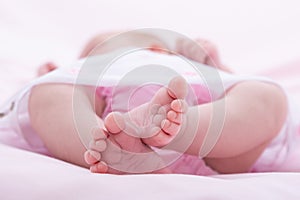 Feet of newborn on white background