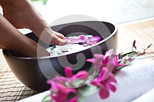 Feet in orchid spa bowl