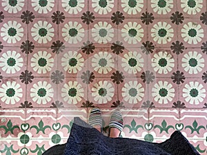 Feet over vintage tiled floor