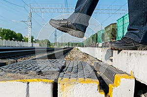 Feet pedestrian step on a pedestrian crossing