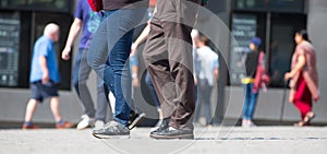 Feet of pedestrians walking on the crosswalk in Oxford street, London. Modern life, travel and shopping concept. UK, London