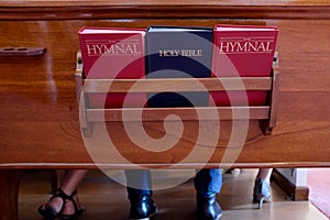 Church Pew With Bible and Hymnal Books photo