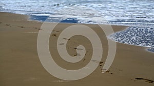 Feet prints on beautiful beach