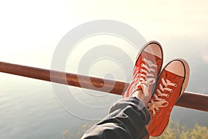 Feet red sneaker a girl in nature and relax time