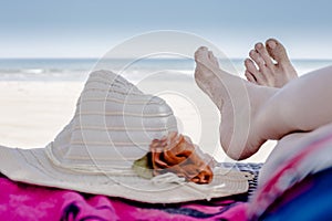 Feet resting at the beach